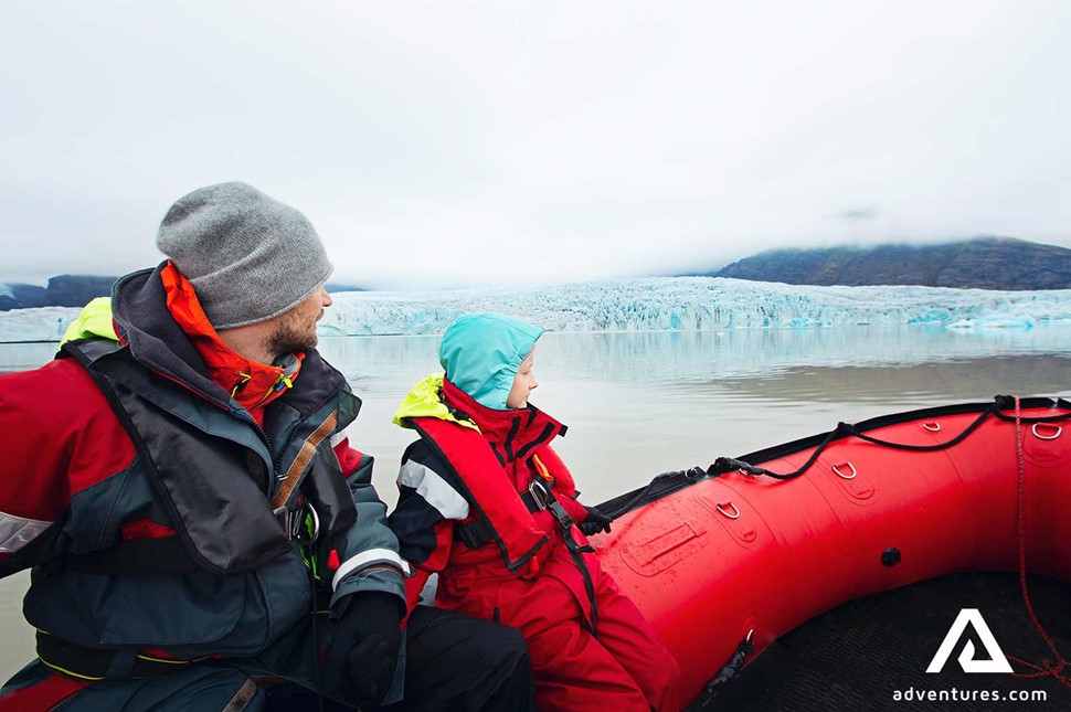 father and son at fjallsarlon on a boat