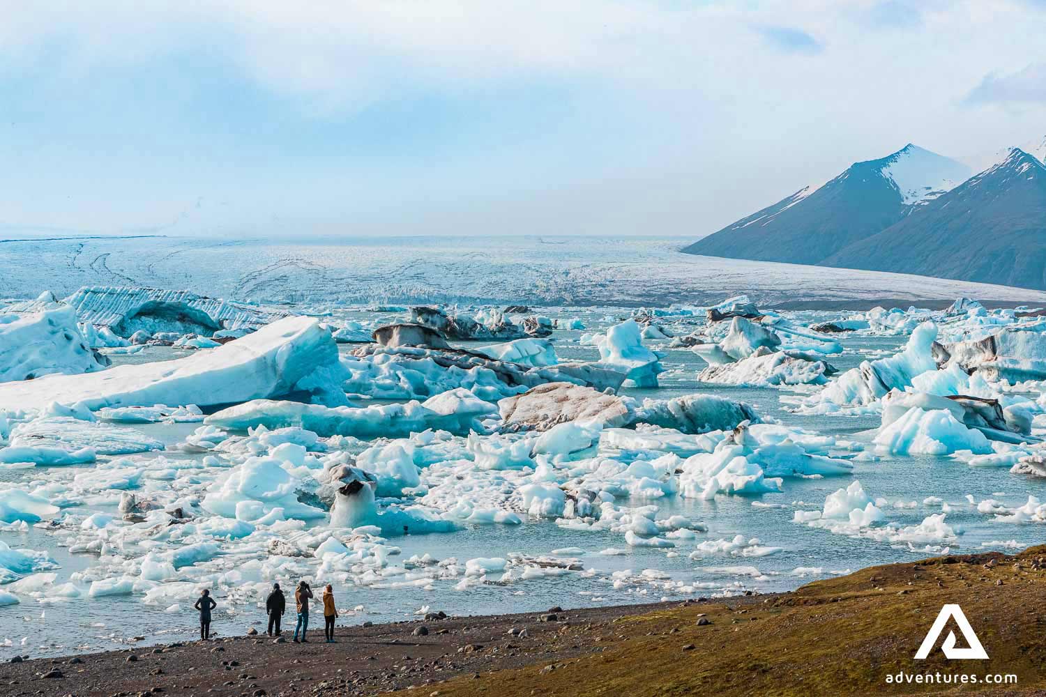 people walking around jokulsalon glacier lagoon