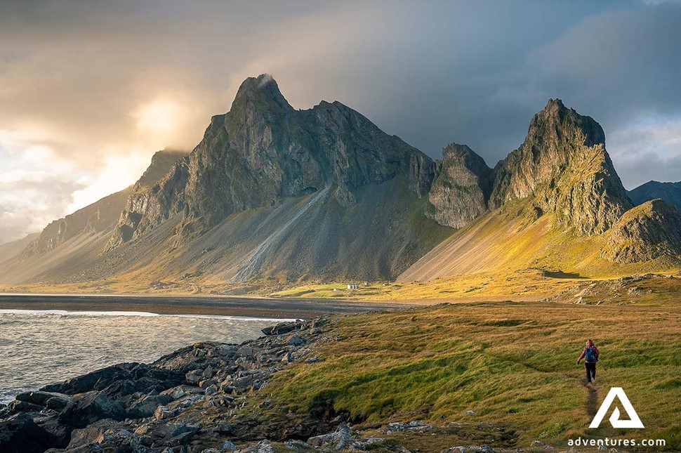 a person hiking towards eystrahorn mountain in iceland