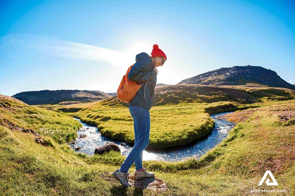 girl hiking around reykjadalur hot spring river