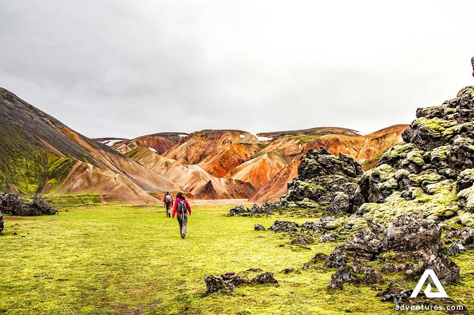 tourists hiking in landmannalaugar area in iceland