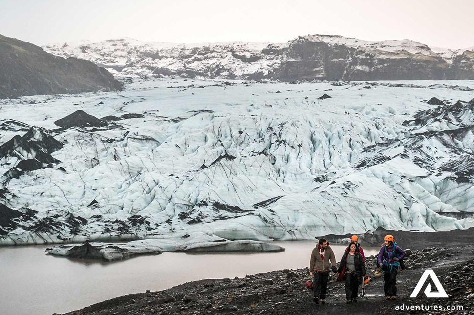 people walking near solheimajokull glacier