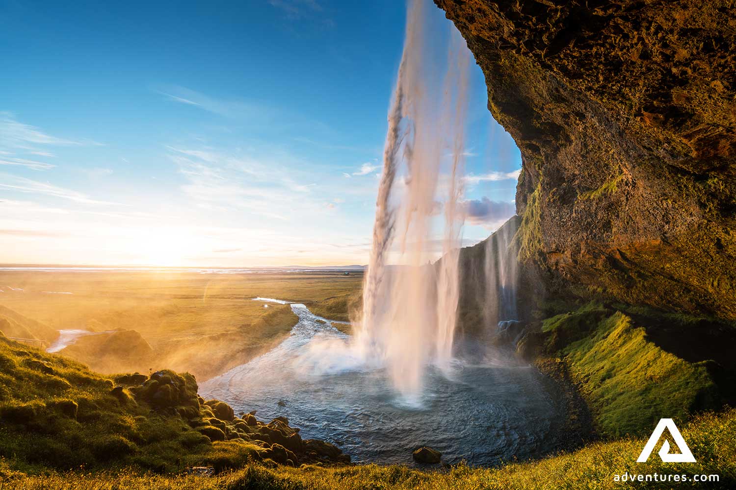 sunset at seljalandsfoss waterfall in iceland south coast