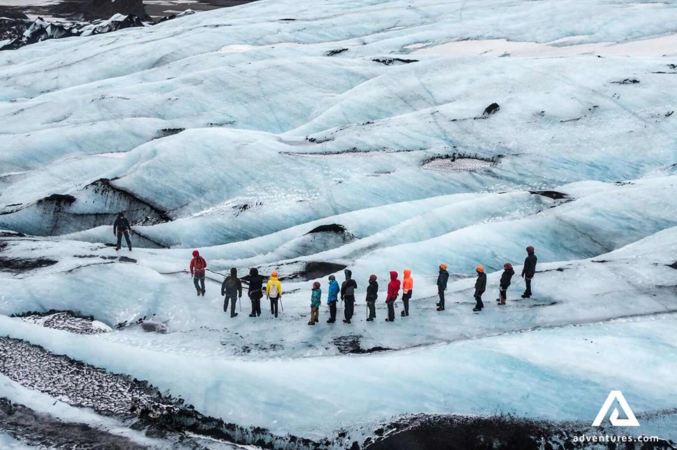 small group hiking on a glacier solheimajokull in south iceland