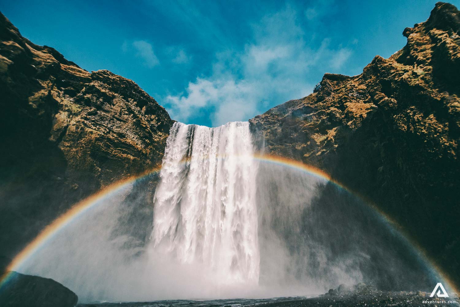 rainbow over skoga river waterfall in iceland