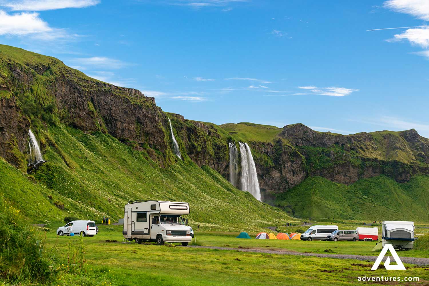 campervan and tents near seljalandsfoss waterfall