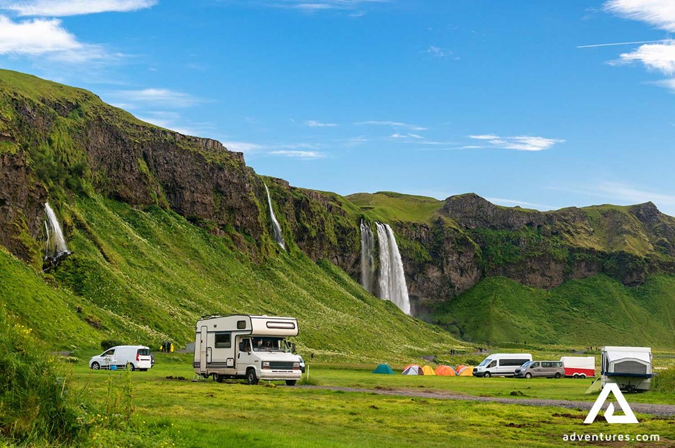 campervan and tents near seljalandsfoss waterfall