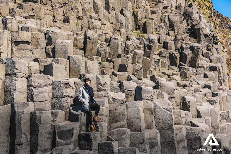 sitting on basalt columns in reynisfjara