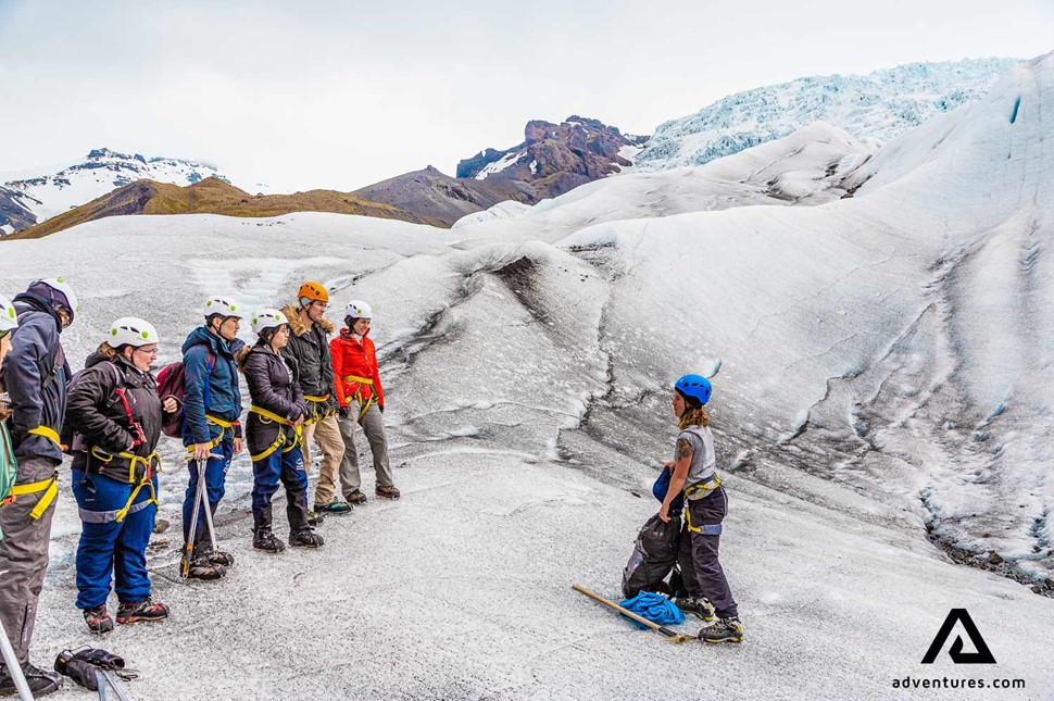 guide instructing people on a glacier falljokull