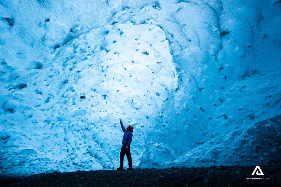 touching ice in a crystal ice cave in iceland