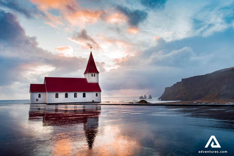vikurkirkja church reflection on water in Vik