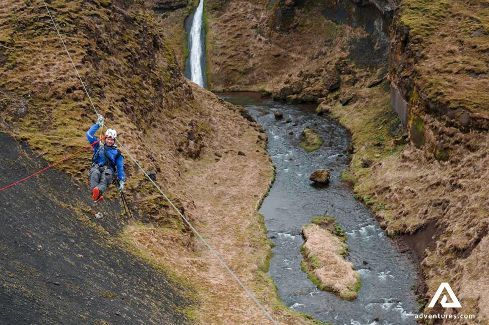 ziplining through a small canyon in iceland