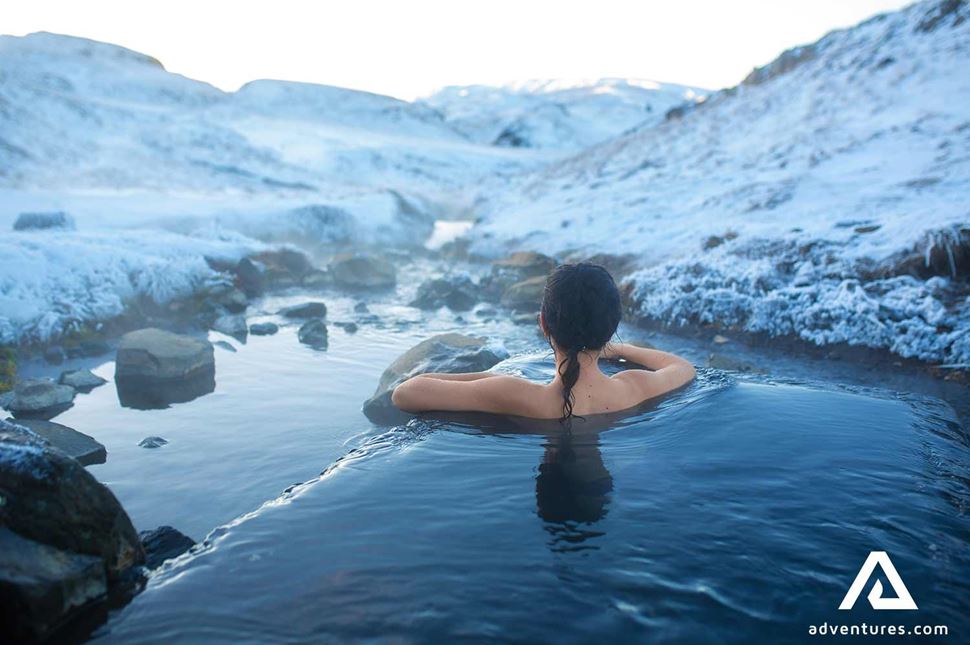 woman bathing in a hot thermal pool in winter