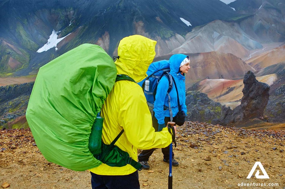 two friends trekking in rainy weather at landmannalaugar