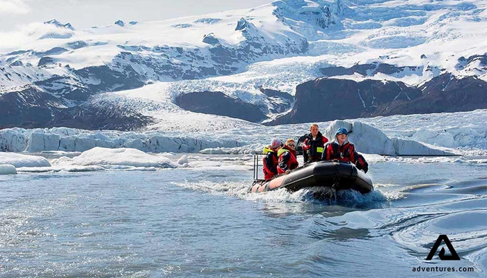 small group with a guide on a zodiac boat tour in Fjallsarlon