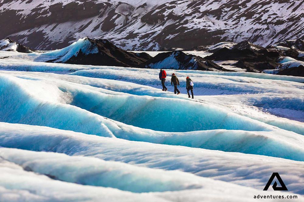 Three people hiking a glacier