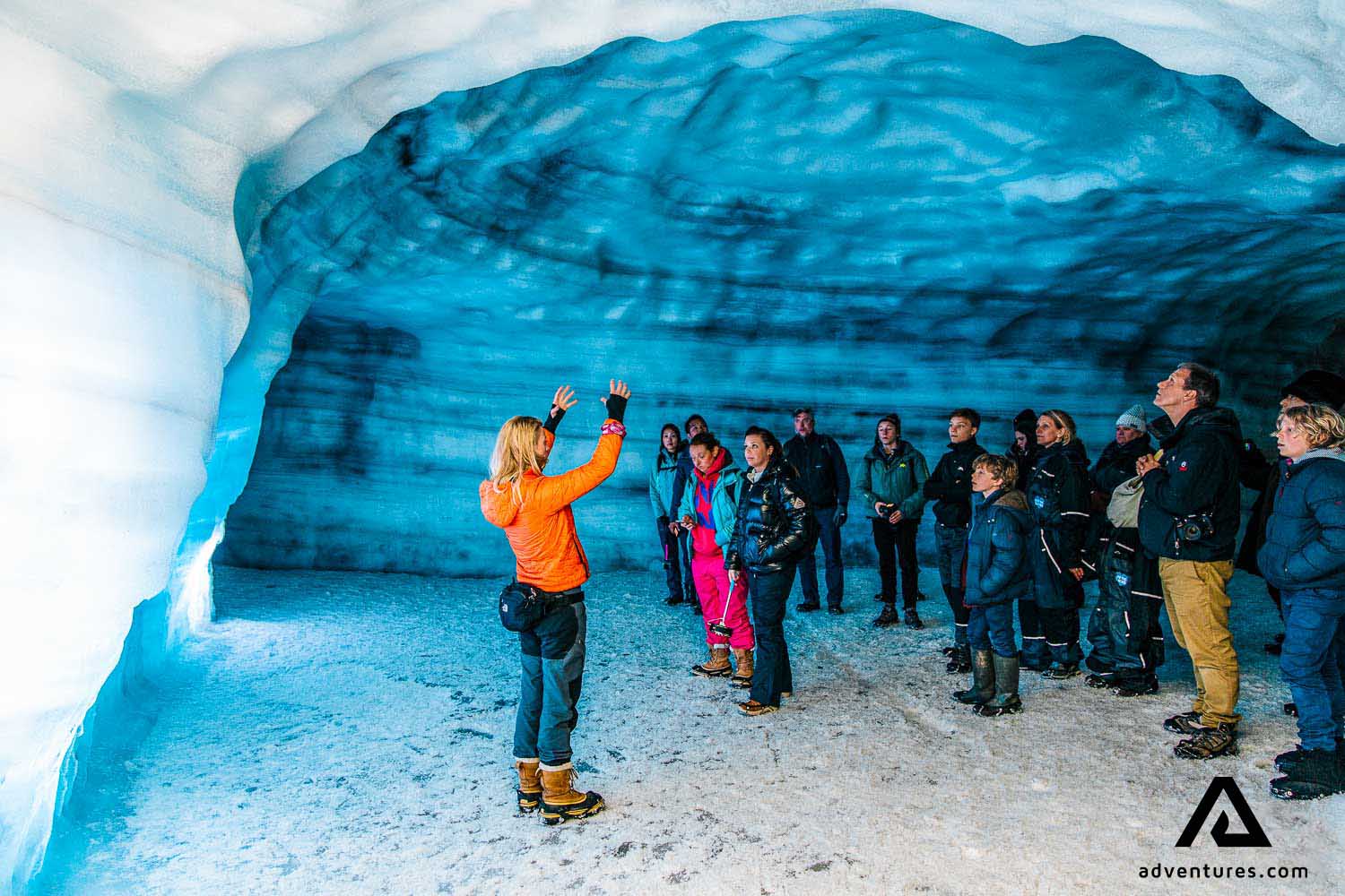 Ice Cave Guide People Into the glacier tunnel