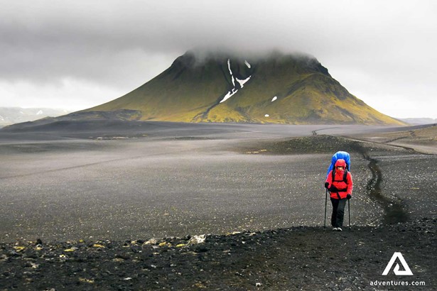 woman trekking laugavegur trail in iceland on a foggy day