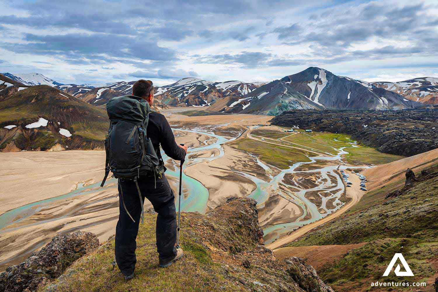 man watching over a mountain range in landmannalaugar in iceland