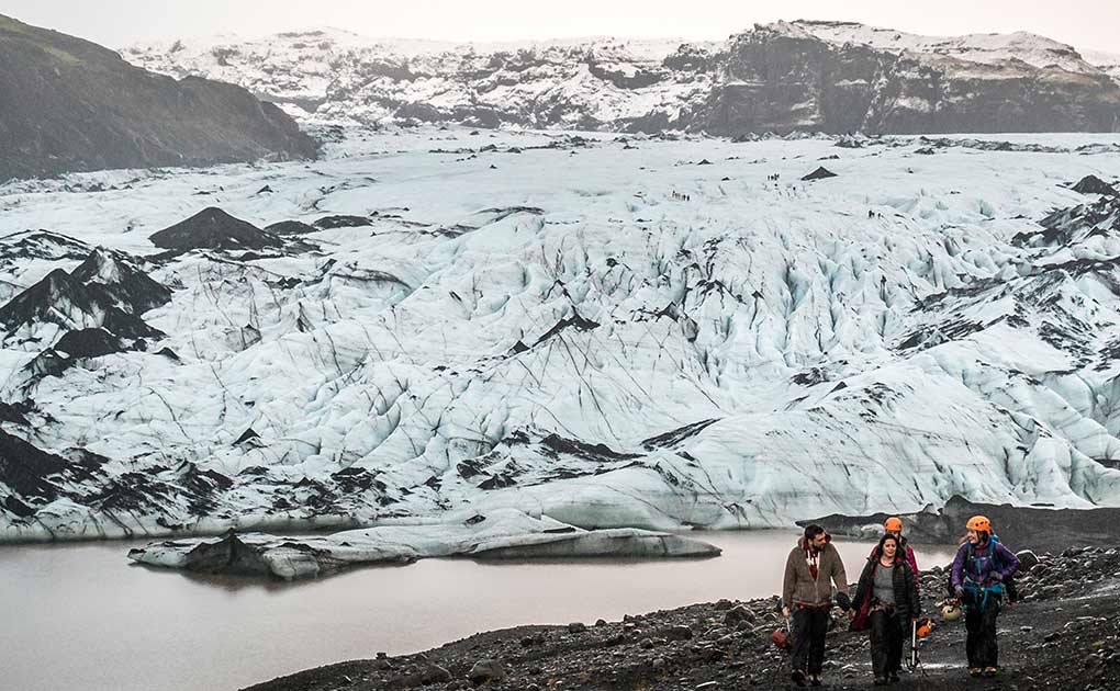 walking after a glacier hike on solheimajokull