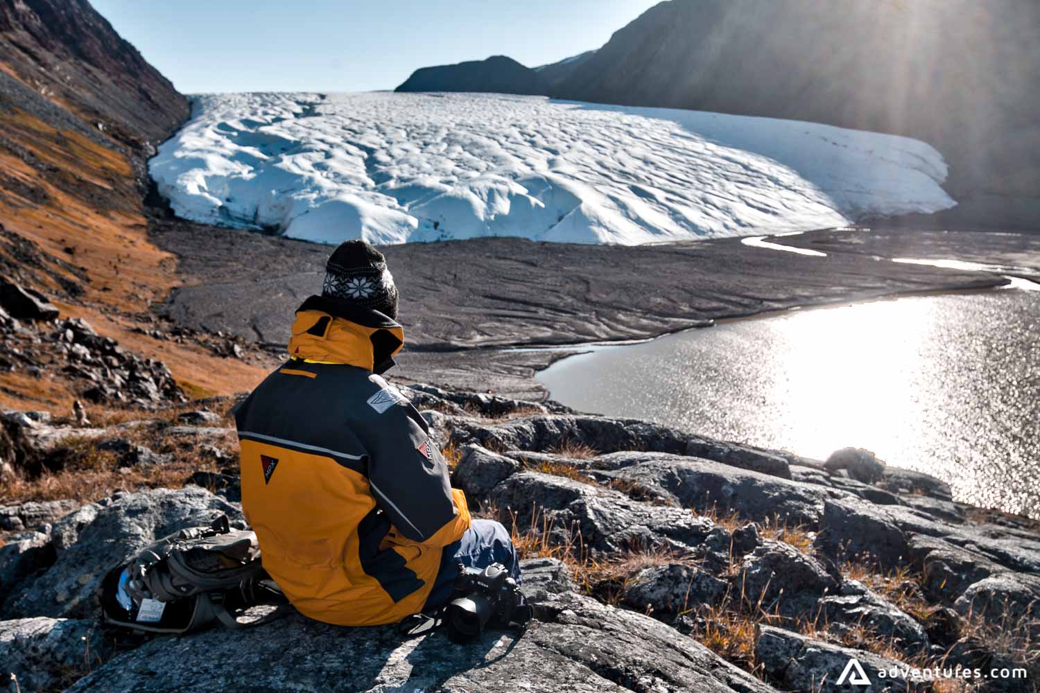 Photographer sitting in front of Glacier Arctic