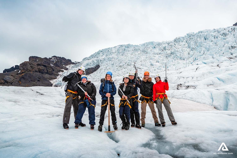group posing on a glacier