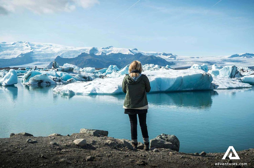 woman looking at jokulsarlon glacier lagoon