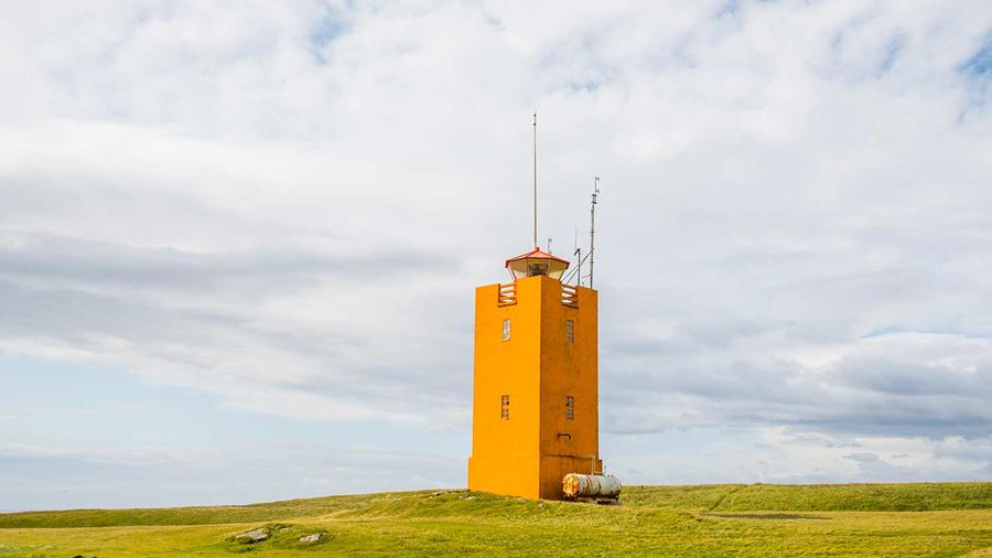 orange lighthouse in ingolfshofdi