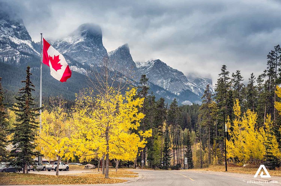 canadian flag on a pole in autumn 