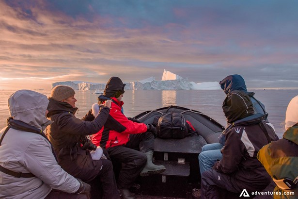 People exploring arctic sea from the boat