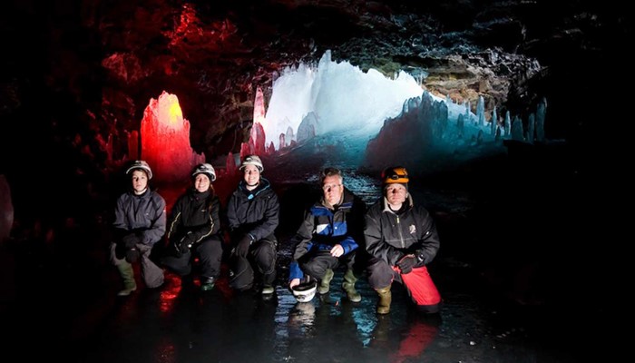 group posing for a picture inside Lofthellir lava cave