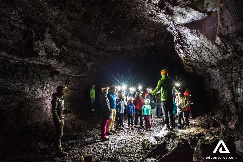 guide with a group exploring a lava cave