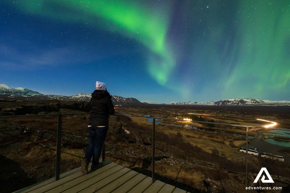 Thingvellir National Park Northern Lights Woman Watching in Iceland
