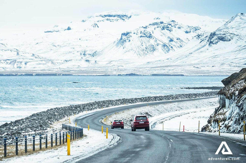 cars driving on an icy road in iceland