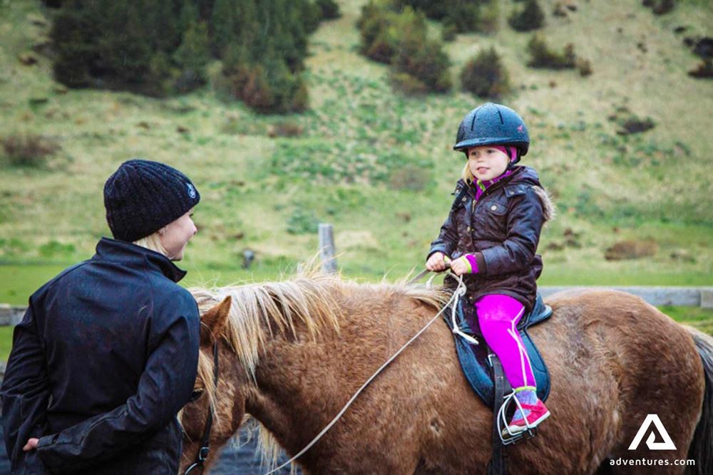 small girl riding a horse