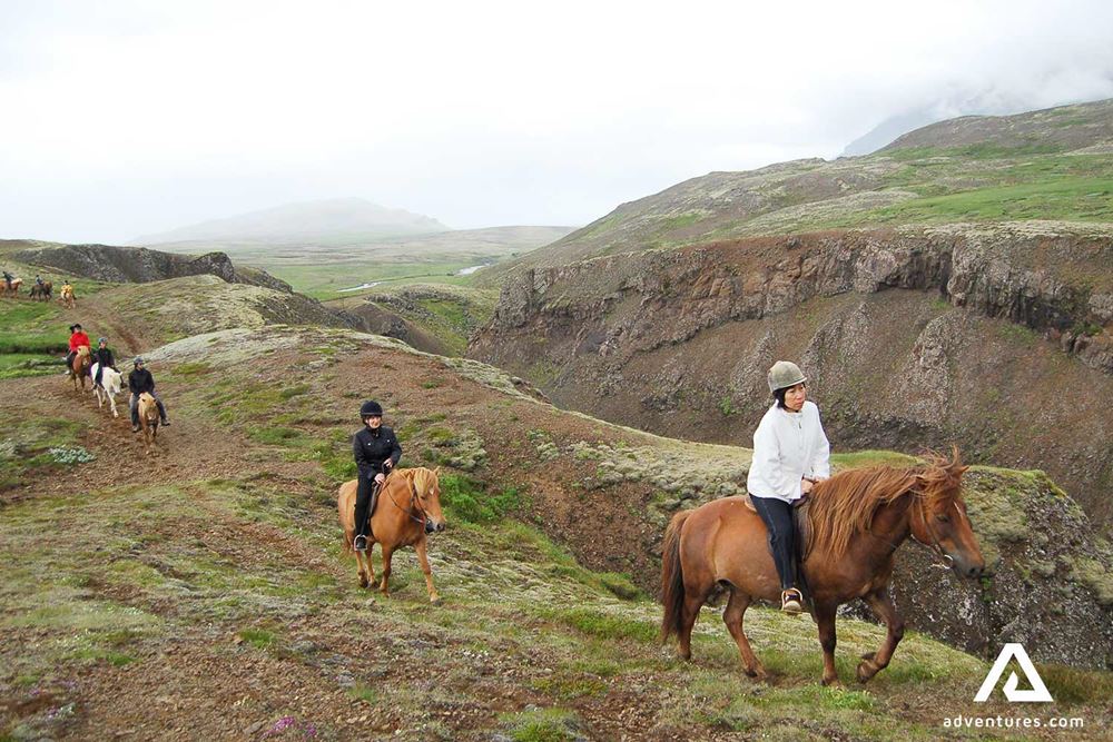 riding horses near a small canyon