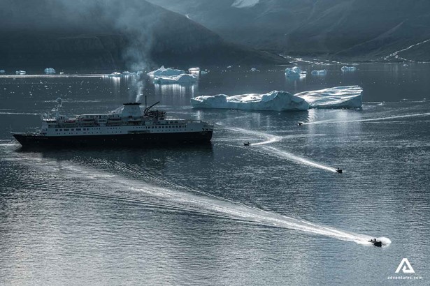 Cruise ship with icebergs around