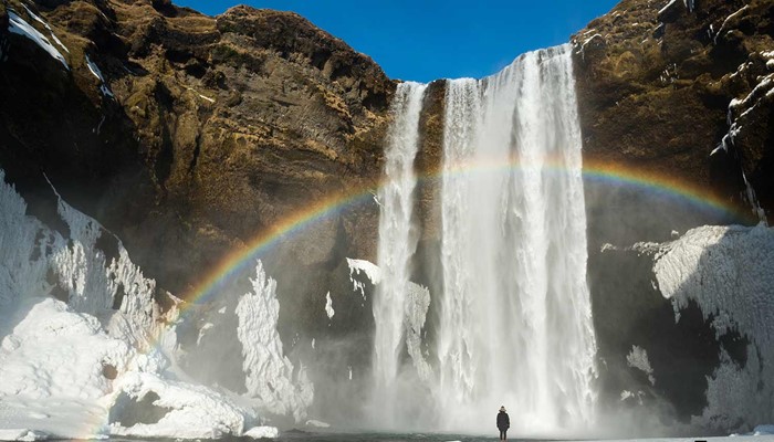 skogafoss waterfall with a rainbow in winter