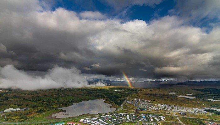 rainbow view from a helicopter with rain clouds in iceland