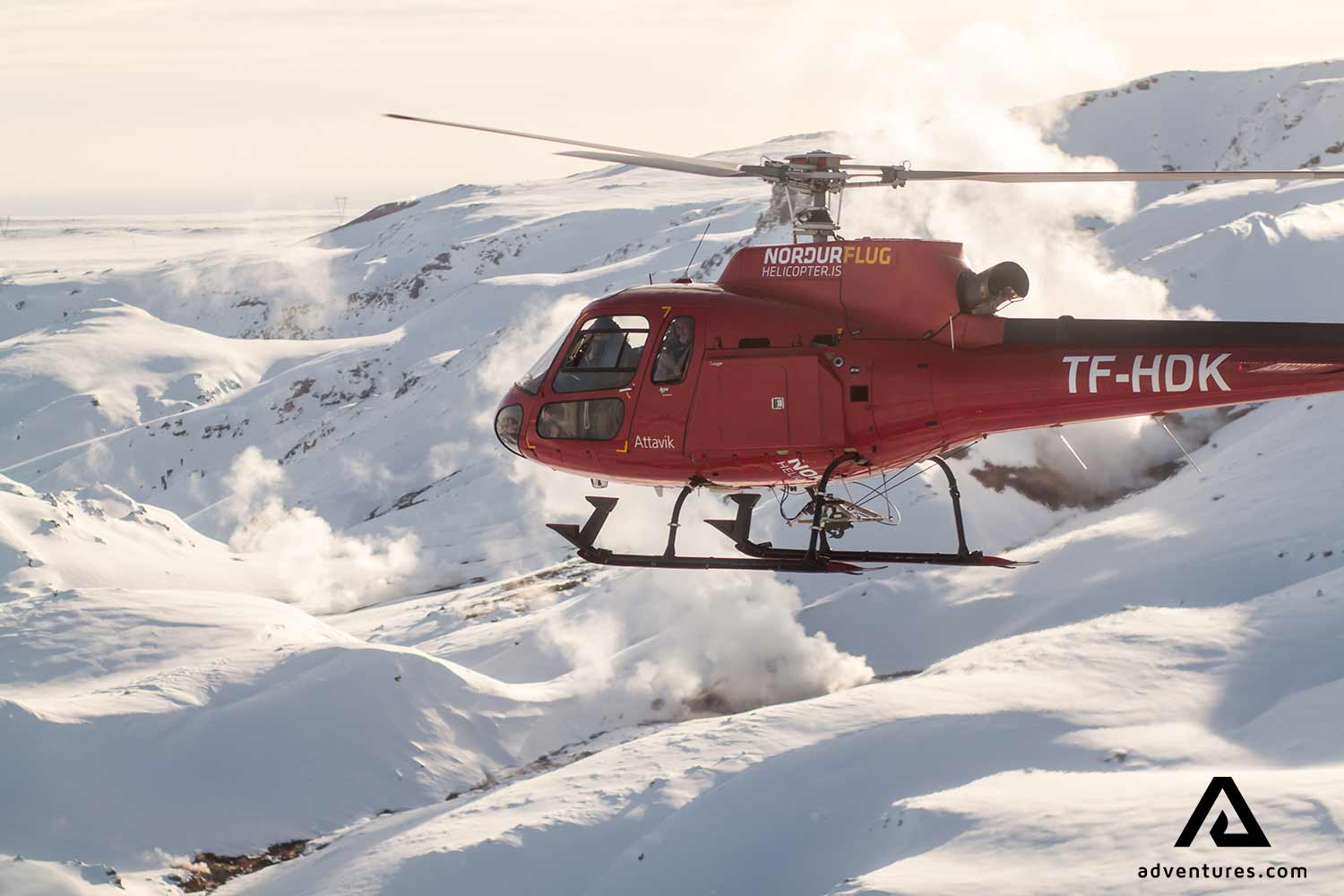 helicopter flying over a mountain range near reykjavik in iceland