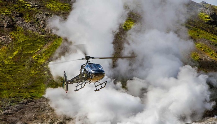 helicopter flying past geothermal area in hveragerdi in iceland