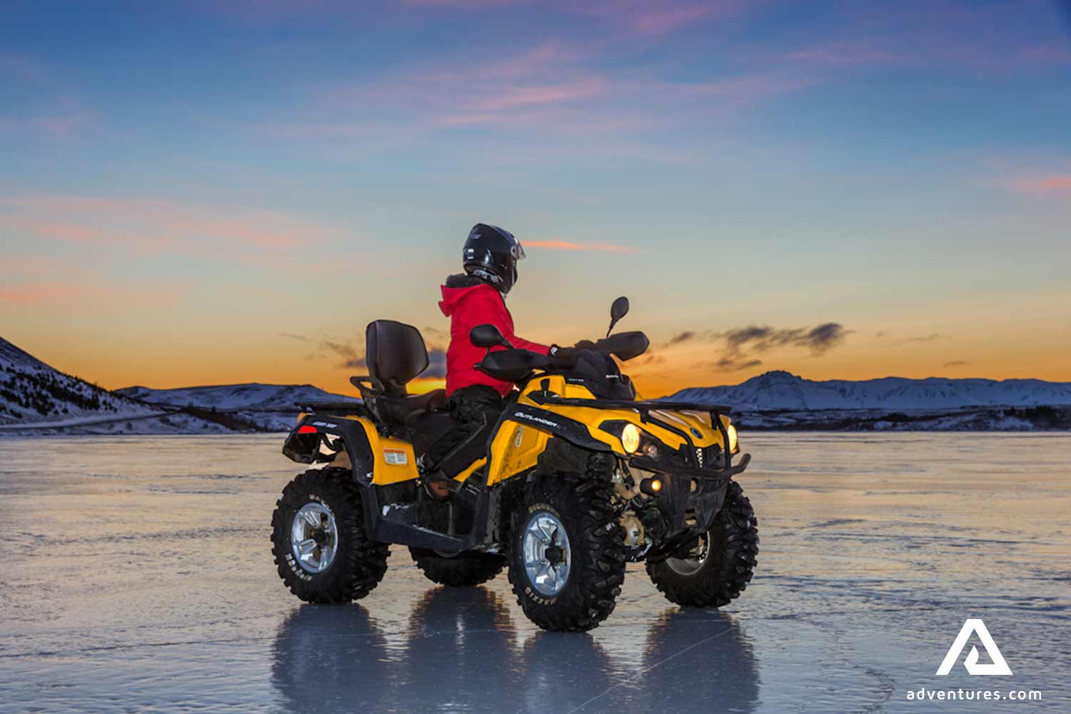 atv riding on a black sand beach