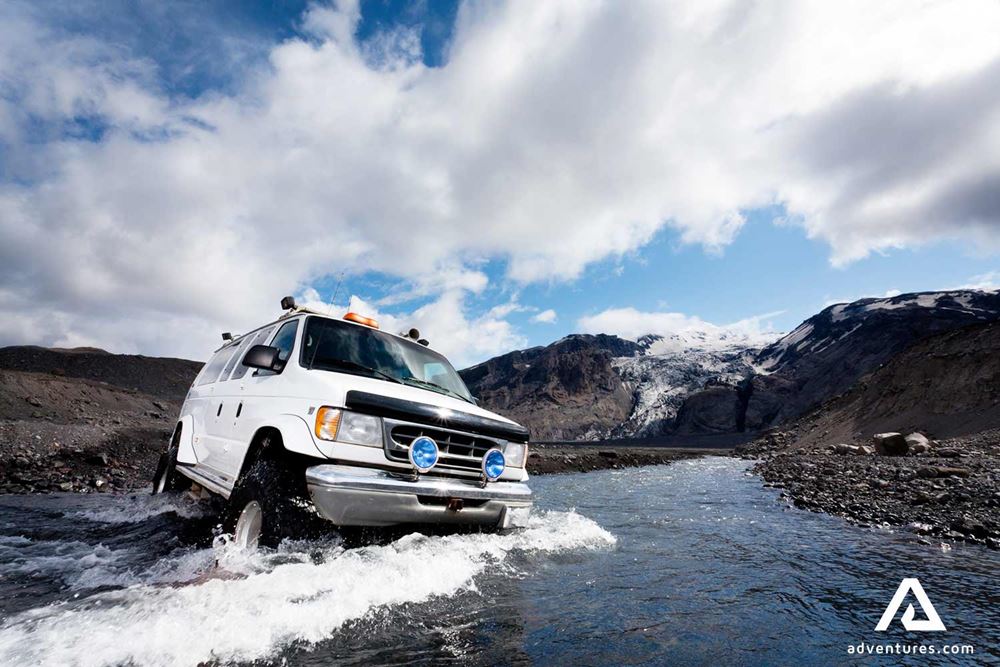 super jeep minibus crossing glacial river