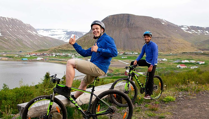 two happy friends on a mountain biking tour in iceland