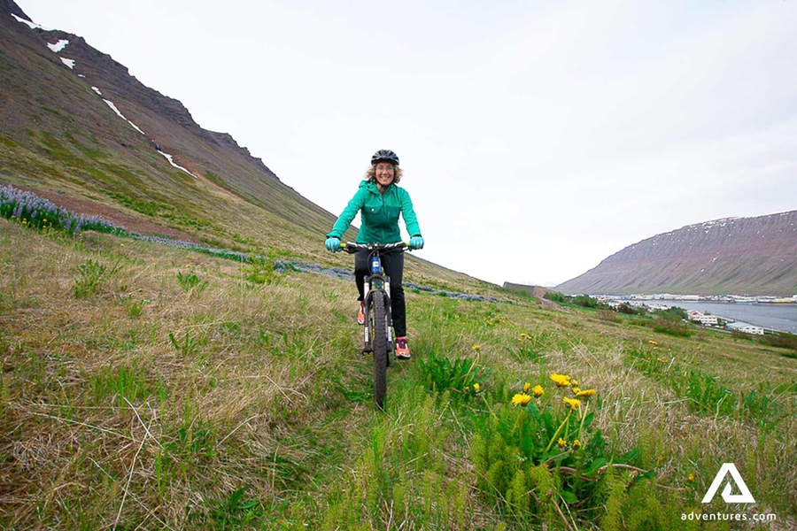 riding a mountain bike through a grassy path