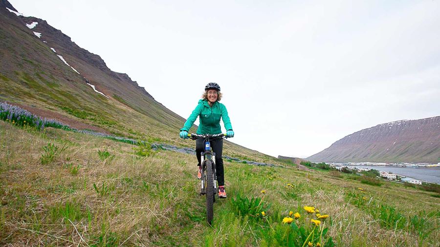 riding a mountain bike through a grassy path