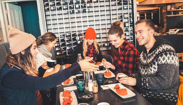 happy group of friends tasting food in reykjavik