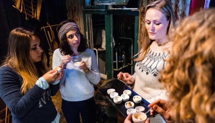 group of women tasting entrees on a food tour