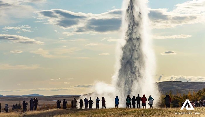 People Standing Near Geysir hot spring