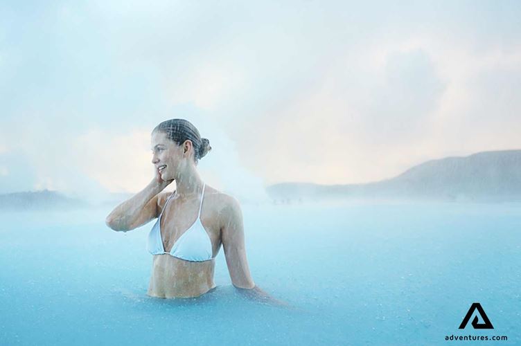 woman bathing in the blue lagoon woman bathing in the blue lagoon geothermal spa